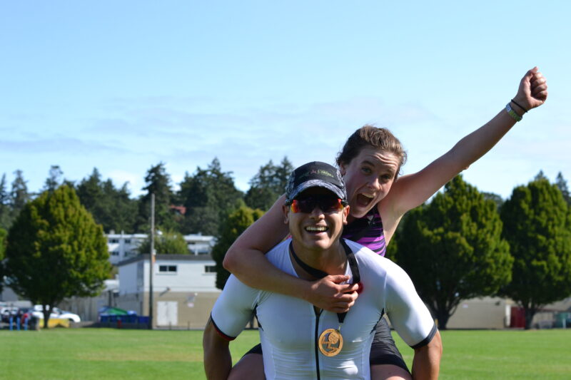 A man and woman on a field with a frisbee.
