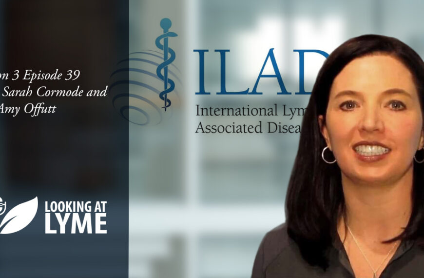 A woman is standing in front of a white background with the words iad.