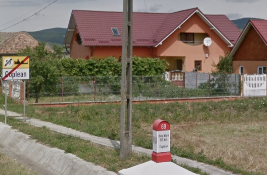 A google street view of a house with a sign in front of it.