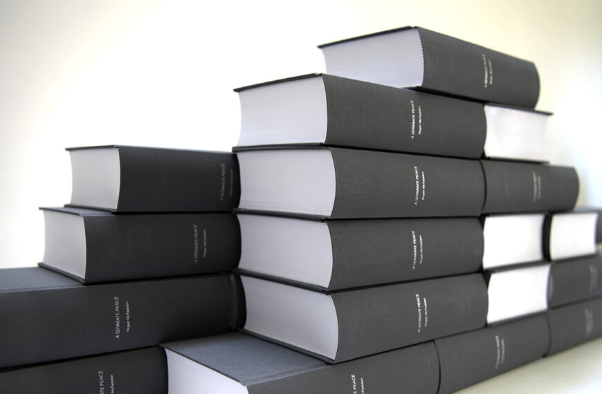 A stack of black and white books stacked on top of each other.