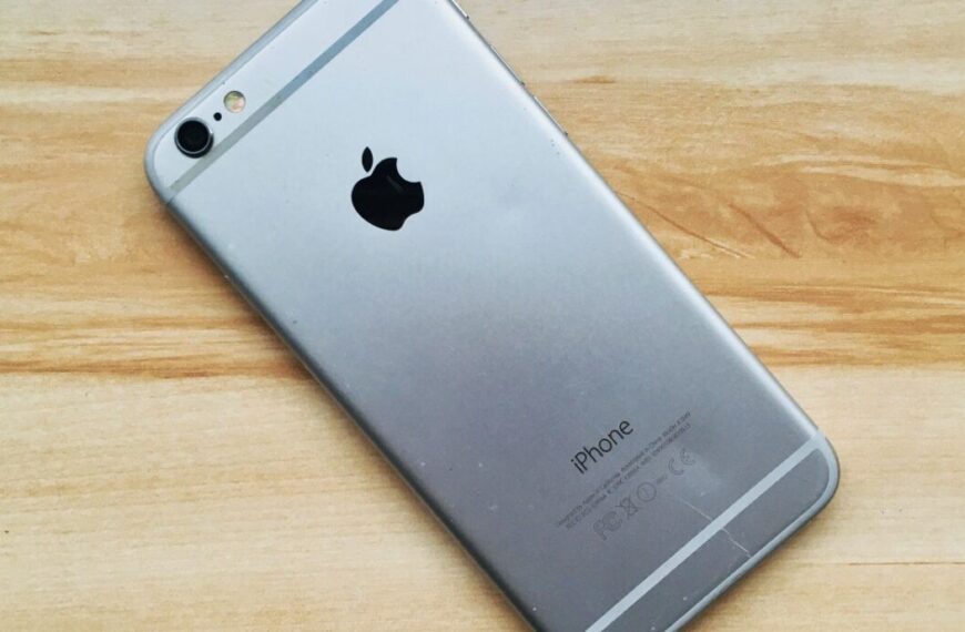 An iphone 6s is sitting on a wooden table.