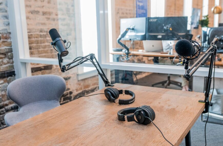 Two microphones on a table in an office.
