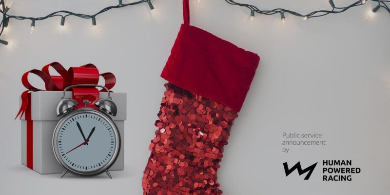 A red christmas stocking with a clock on it.