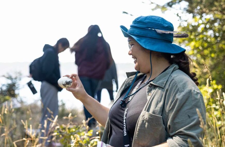 A group of people in a field looking at something.