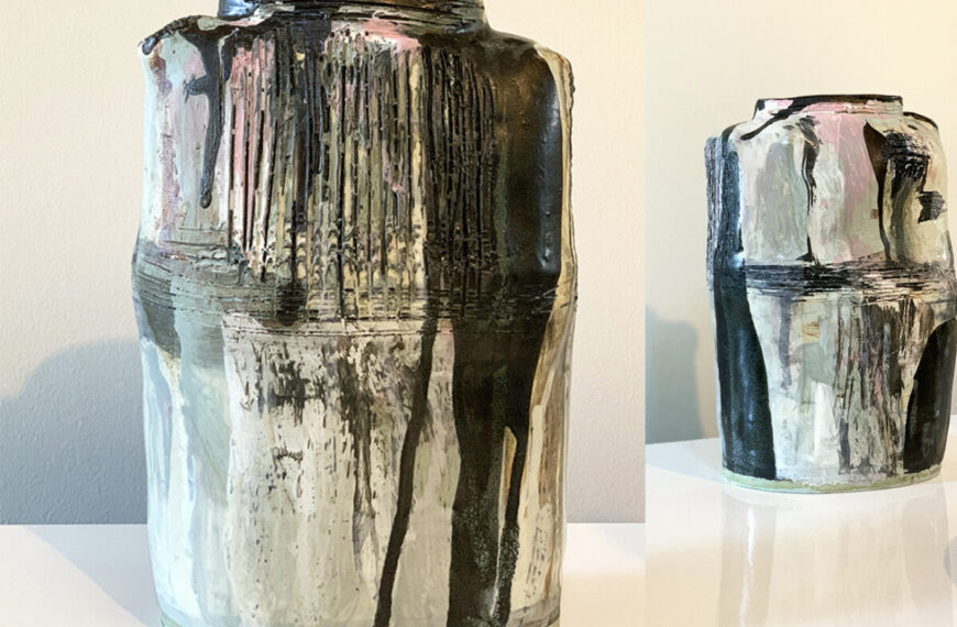 Two vases with black and grey paint on them.