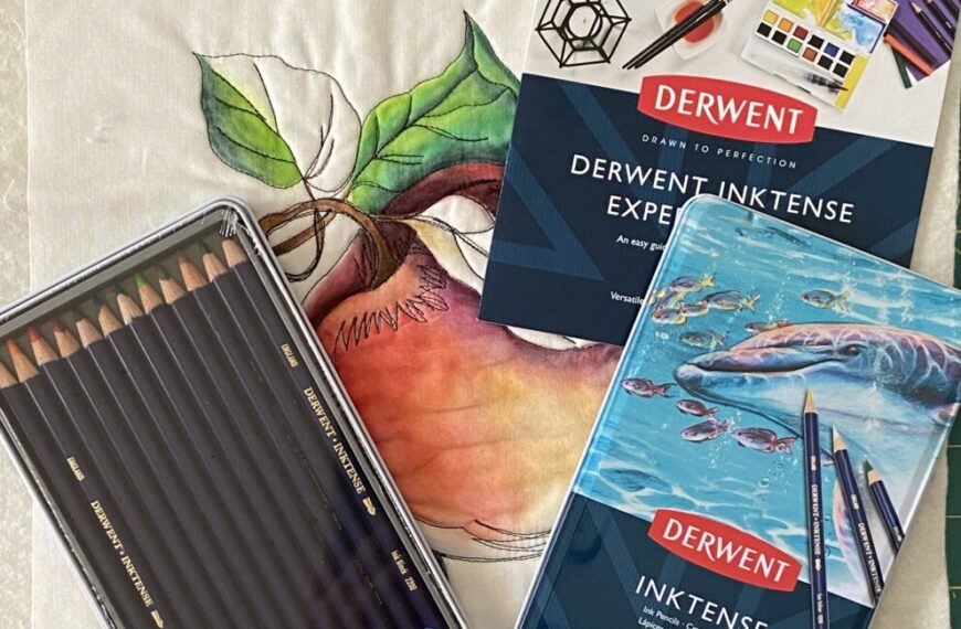 A set of colored pencils and a tin on a table.