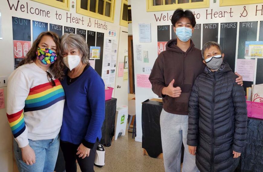 Three people wearing face masks standing in front of a wall.