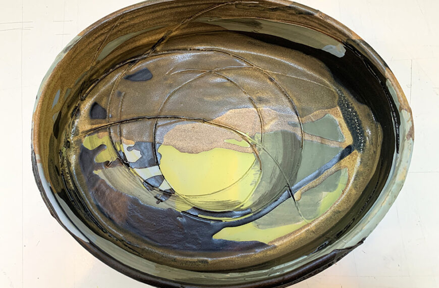 A black and yellow bowl on a table.
