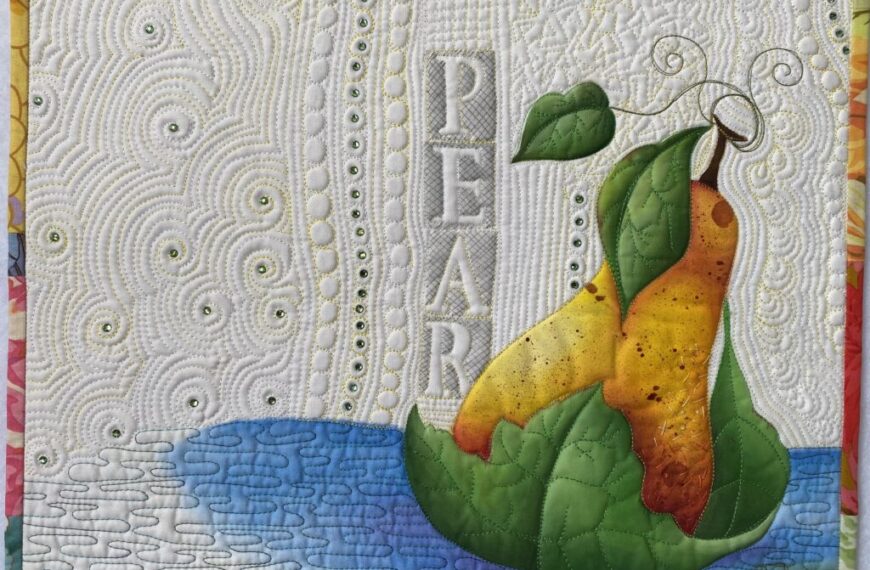A quilt with an image of a pear on it.