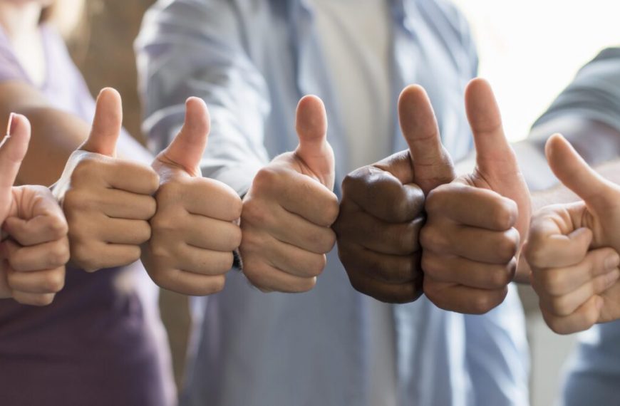 A group of people giving thumbs up.