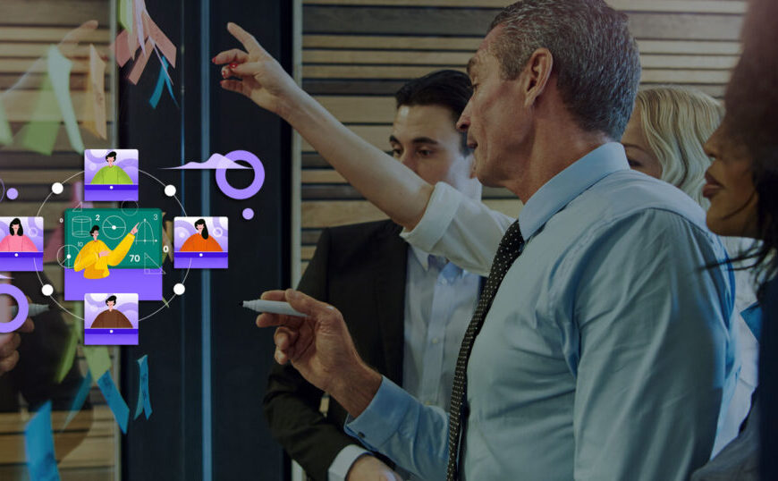 A group of people pointing at a screen.