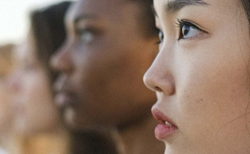 A line of women looking at each other.