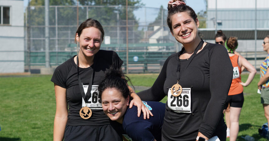 Three women posing for a photo at a race.