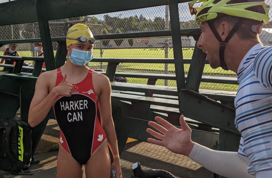 A man is talking to a woman while wearing a face mask.