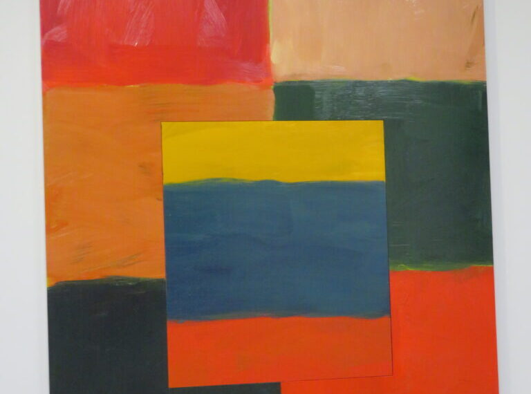 A red, orange, yellow, and blue painting on a wall.