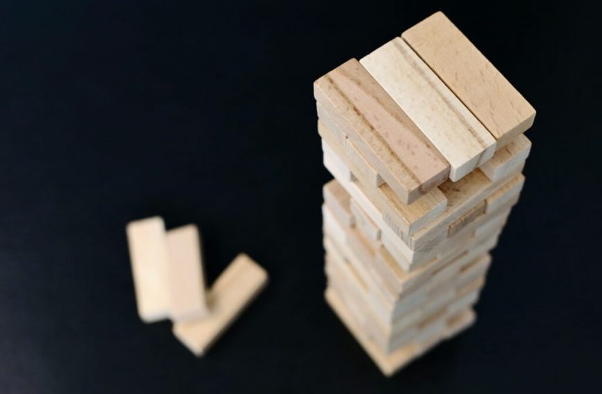 A stack of wooden blocks on a black surface.