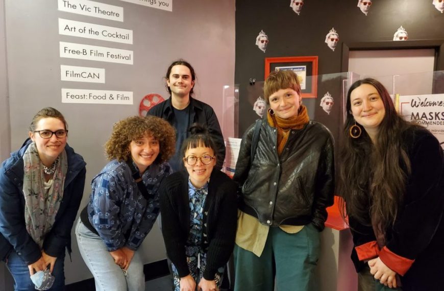 A group of people posing for a photo in a museum.