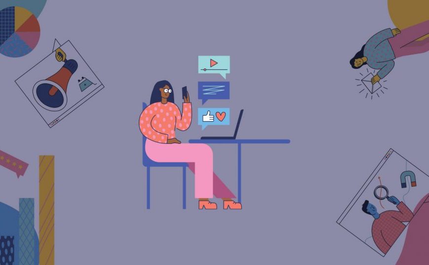 A woman is sitting at a desk with a laptop in front of her.
