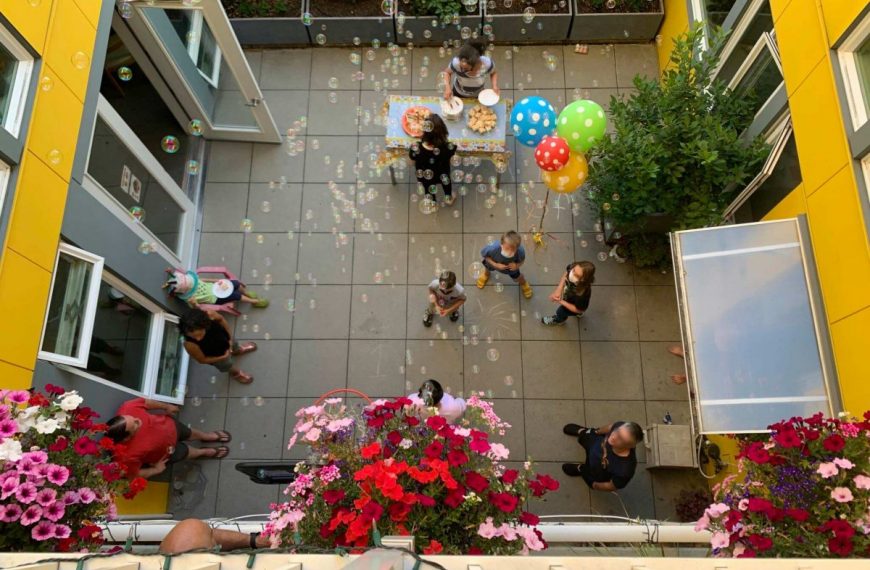 An aerial view of a courtyard with people and balloons.