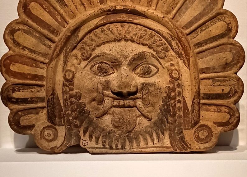 An indian head on display in a museum.