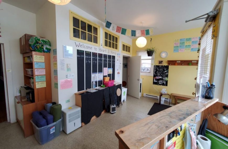 A room with a desk and a lot of items on it.