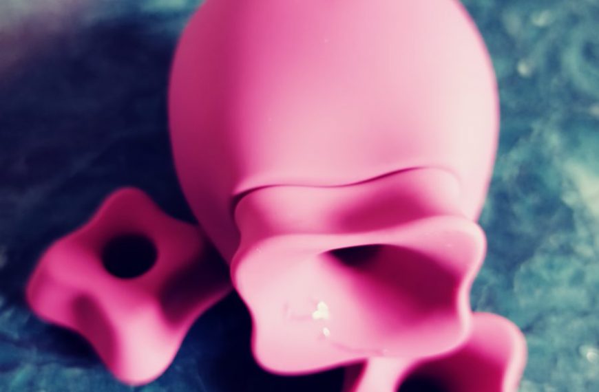 A pink toy sitting on top of a blue surface.