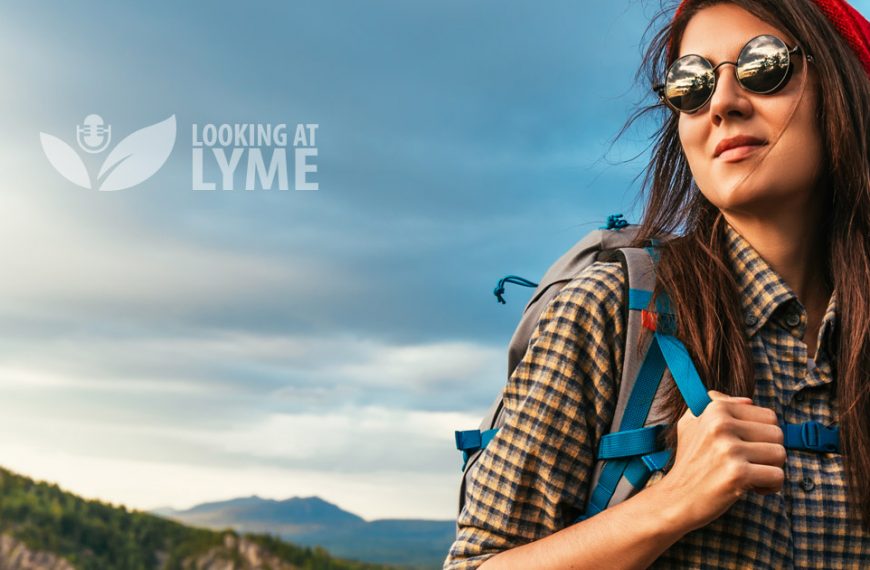 A woman wearing sunglasses and a backpack with the words looking of lyme.