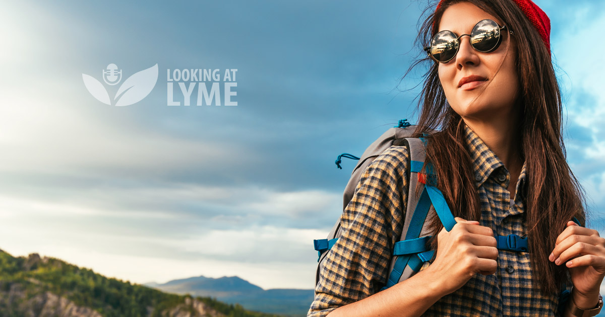A woman wearing sunglasses and a backpack with the words looking of lyme.
