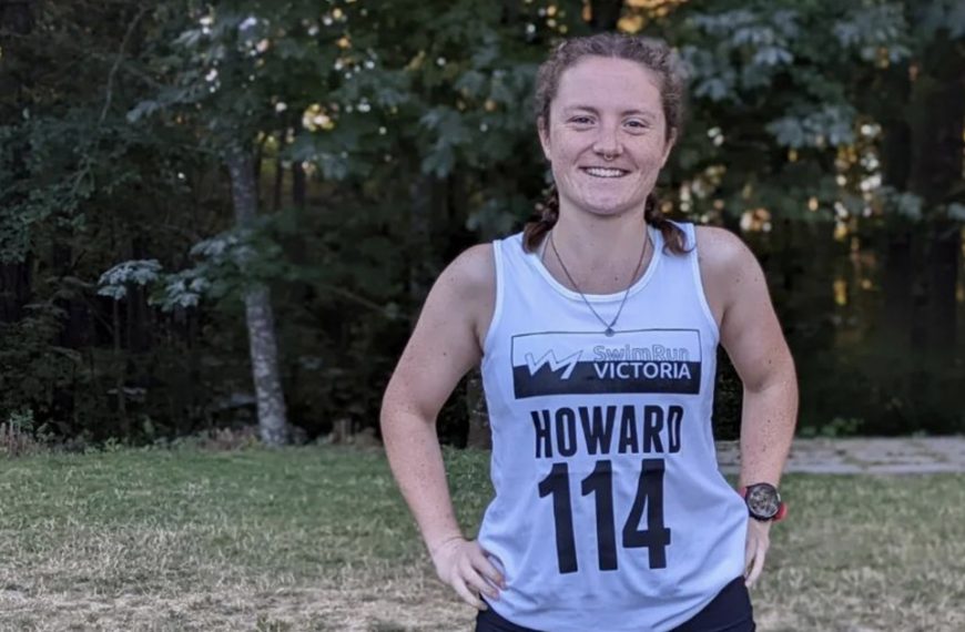 A woman wearing a shirt with the number 14 on it.