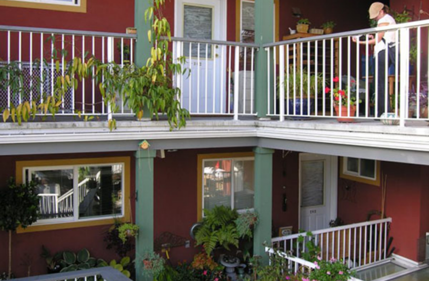 A woman standing on a balcony.