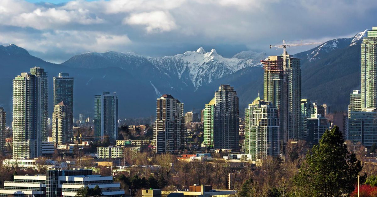 The skyline of vancouver with mountains in the background.