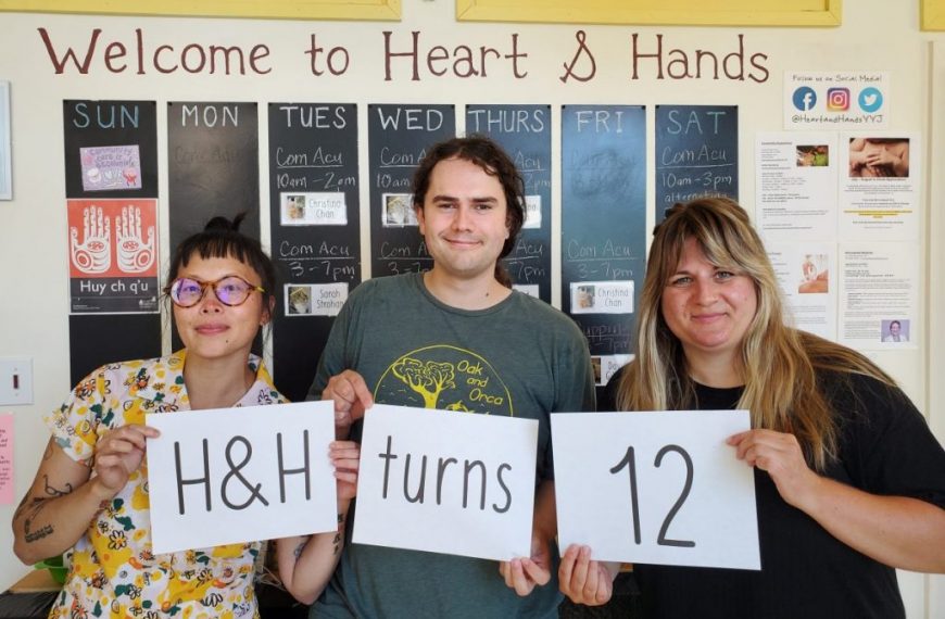 Three people holding up signs that say welcome to heart and hands.
