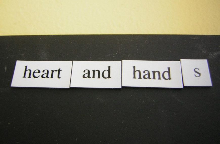 The words heart and hands are written on a piece of paper.