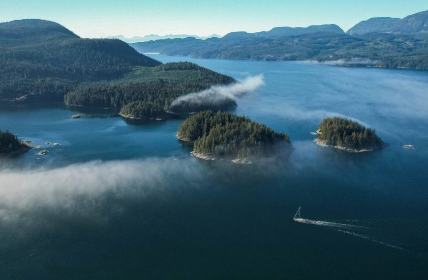 An aerial view of a body of water with a boat in it.