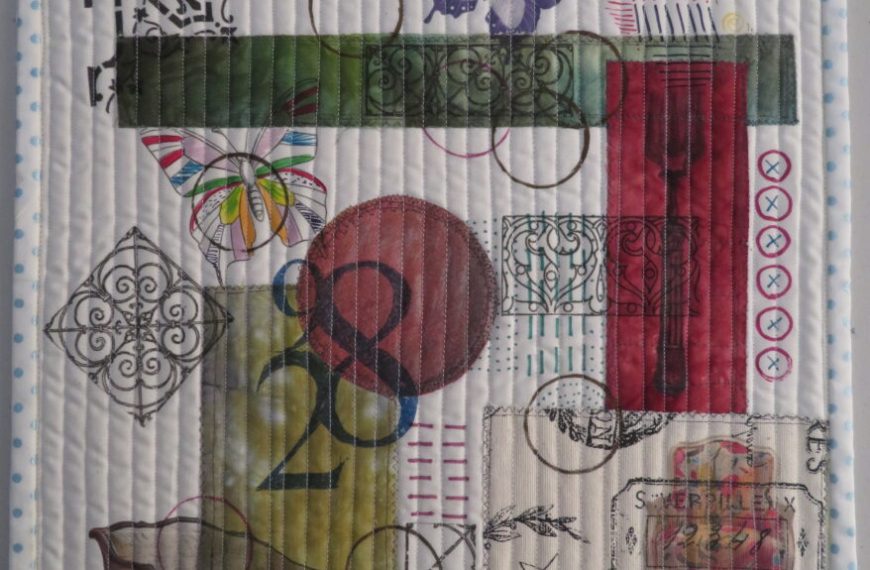 A quilted piece with various objects on it.