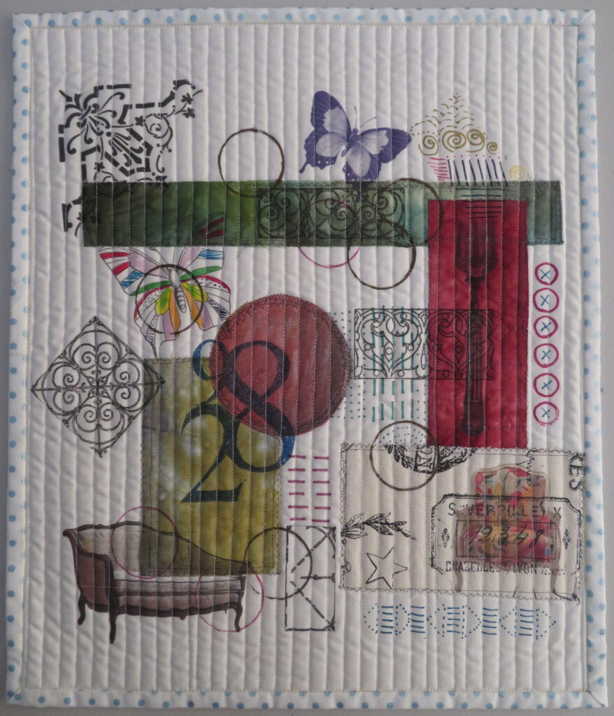 A quilted piece with various objects on it.