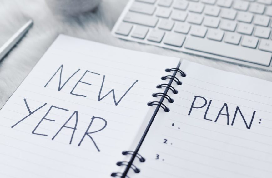 A notebook with the words new year plan written on it.