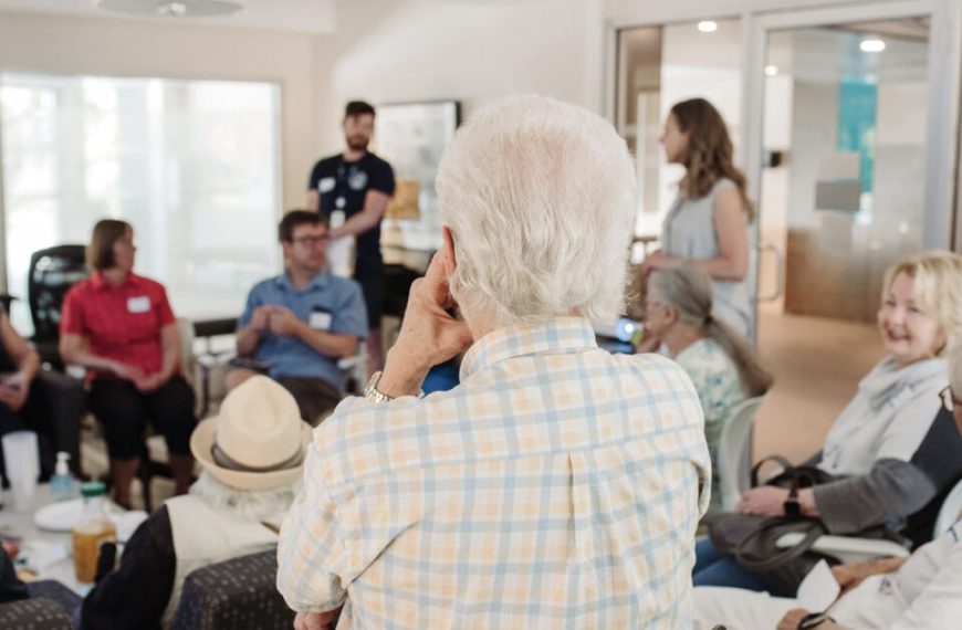 A group of elderly people sitting in a room.