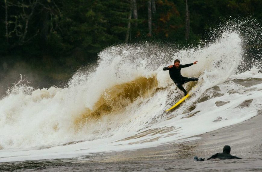 A man riding a wave on a surfboard.