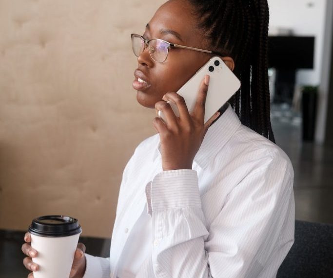 Young african american woman talking on the phone in the office.