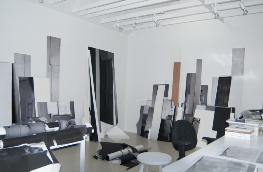 A black and white room with a table and chairs.