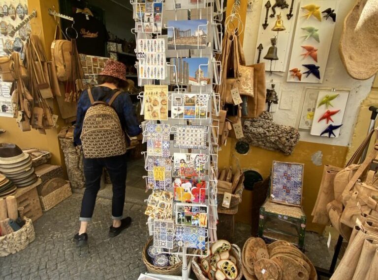 A woman is looking at various items in a market.
