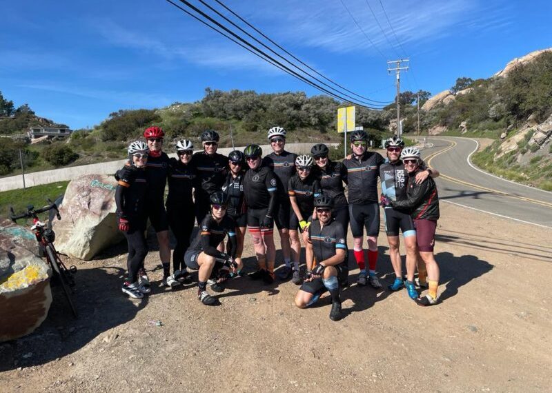 A group of cyclists posing for a photo.