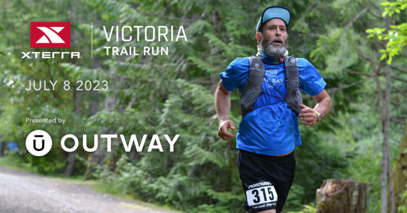 A man is running on a trail with the words victoria trail run.