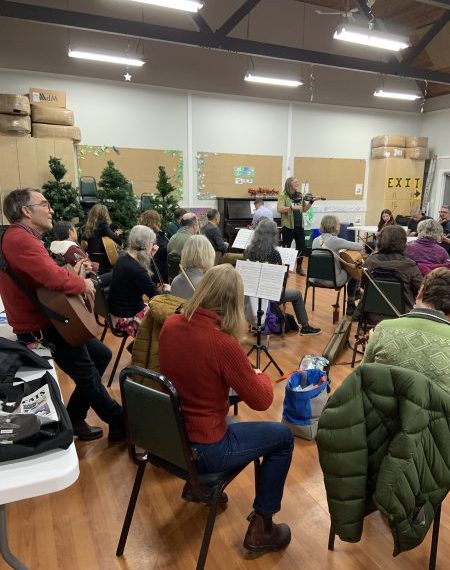 A group of people in a room playing music.