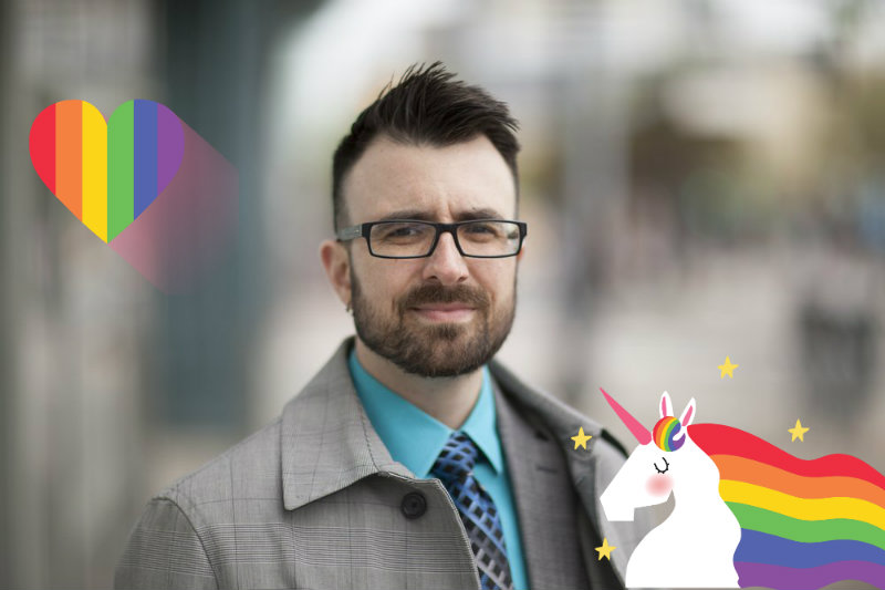 A man with glasses and a unicorn in front of him.
