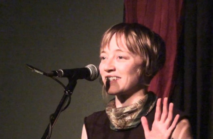 A woman is speaking into a microphone.