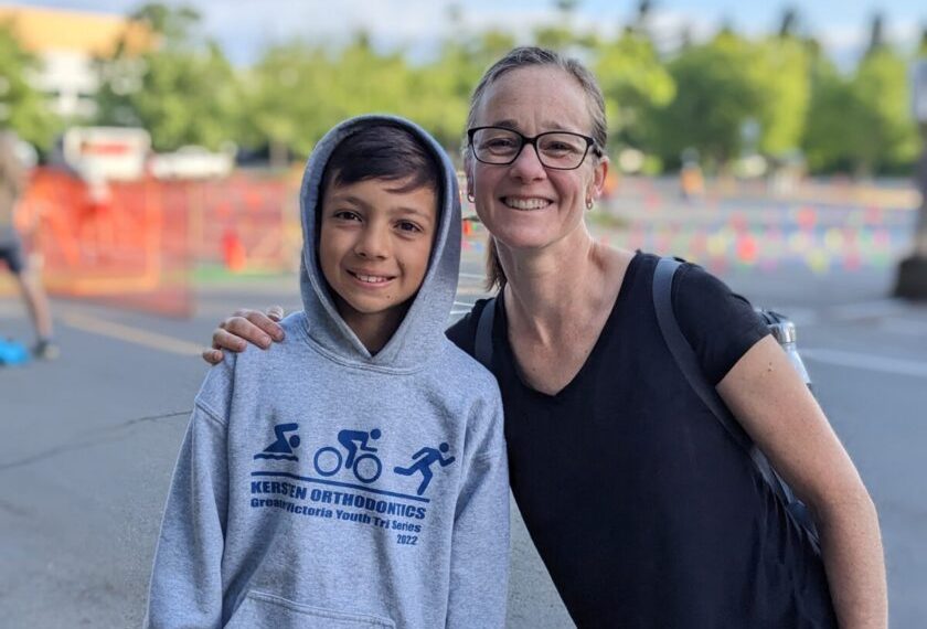 A woman in a hoodie and a boy in a hoodie.
