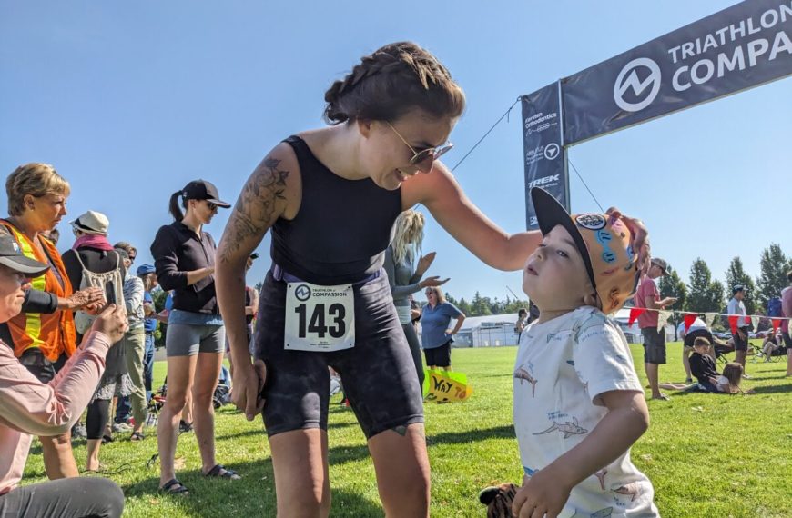 A woman is helping a child at a race.