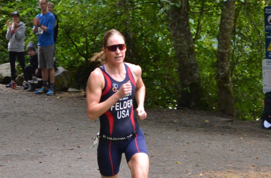 A woman in a swimsuit running down a path.